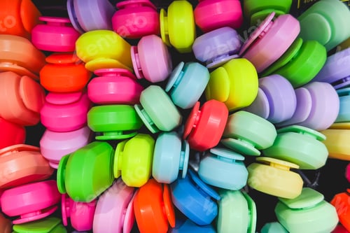 Preview: Numerous bright plastic markers scattered creating a colorful background