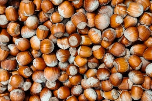 Preview: Pile of whole hazelnuts on a surface