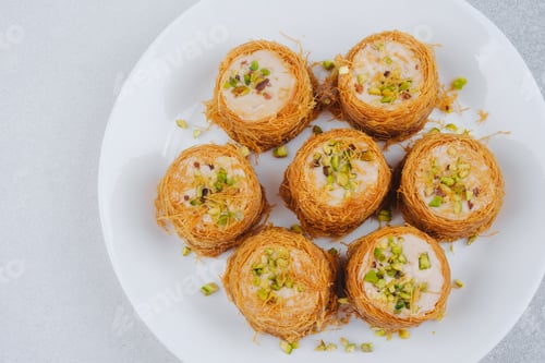 Preview: Middle Eastern Kataifi desserts with pistachios on a white plate