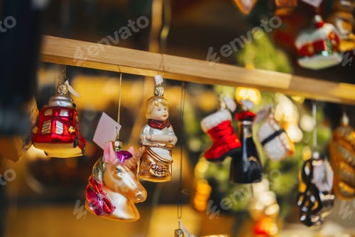 Preview: Christmas ornaments hanging on a wooden bar