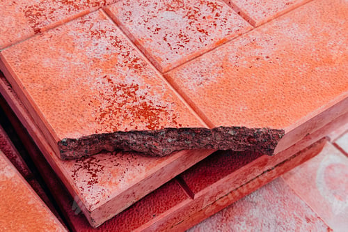 Preview: Stack of textured red paving stones outdoors