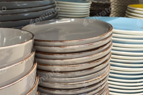 Preview: Assorted ceramic plates and bowls stacked on shelf