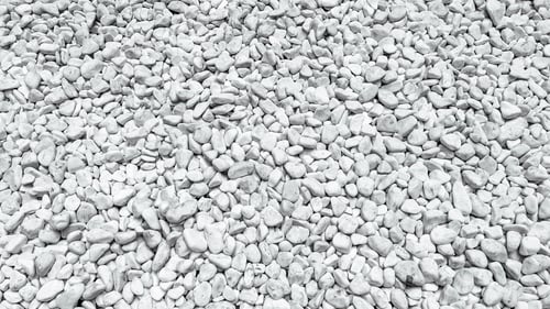 Preview: Close up view of numerous small white decorative stones creating a detailed natural background textu