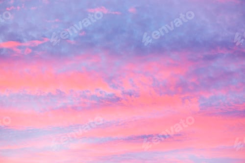 Preview: Clouds painted with pink and purple hues in the sky