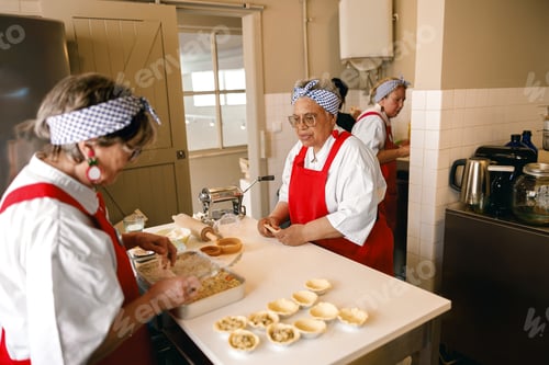 Preview: Diverse Senior Women Preparing Homemade Pastries in a Community Kitchen Setting