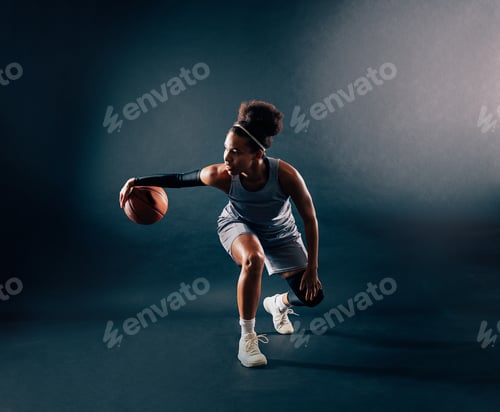 Preview: Young professional basketball player in team uniform showing skill in dribbling