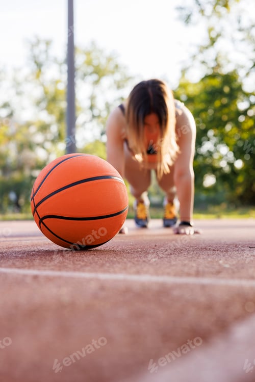 Preview: Woman doing push ups while working out outdoors