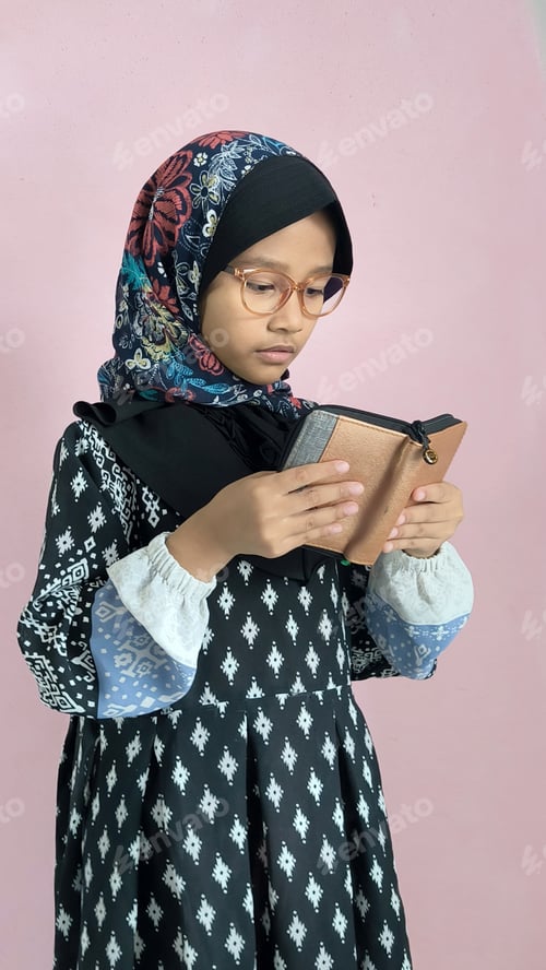Preview: Muslim Girl Reading Quran with Peaceful Expression