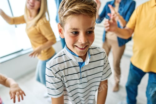 Preview: Happy Young Boy Smiling During a Family Celebration Indoors