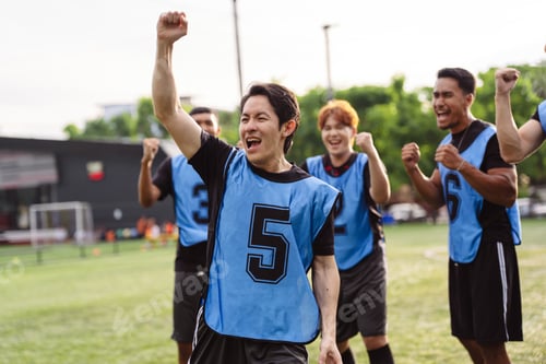 Preview: Excited soccer team cheering and raising fists to celebrate victory. Teamwork, passion, and success