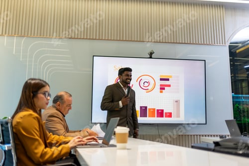 Preview: Smiling Young Asian Presenter Sharing Data Charts in Business Meeting