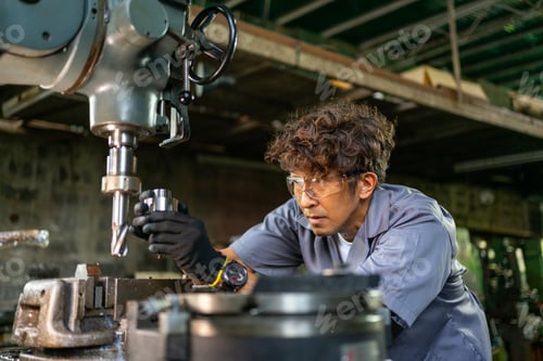 Preview: Engineer Examining Machine Part in Metalworking Workshop