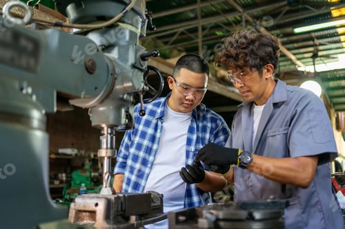 Preview: Engineer Examining Machine Part in Metalworking Workshop