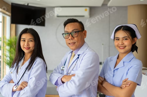 Preview: Confident doctor, physician and nurse posing together in clinic