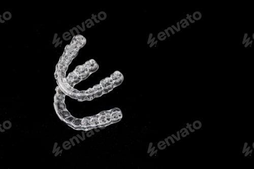 Preview: Transparent dental aligners on black background orthodontic treatment