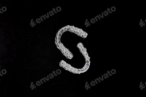 Preview: Transparent dental aligners on black background orthodontic correction concept