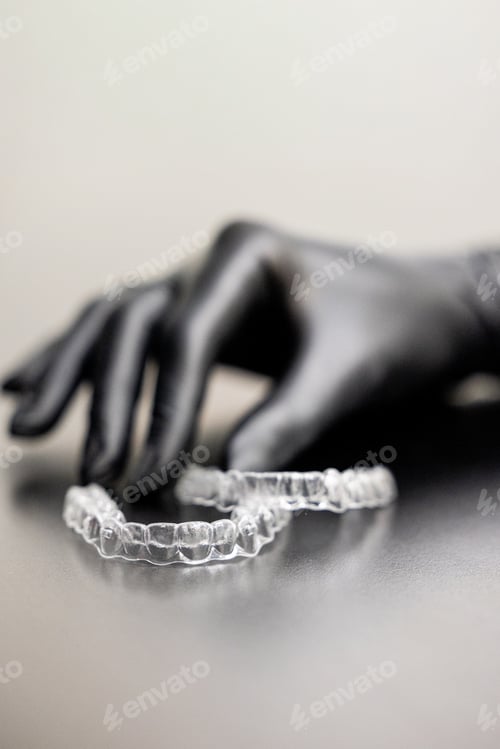 Preview: Orthodontic clear aligners demonstration by dentist close up