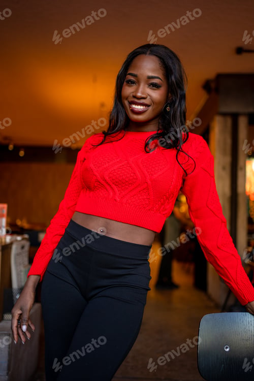 Preview: Young black woman smiling in red crop sweater