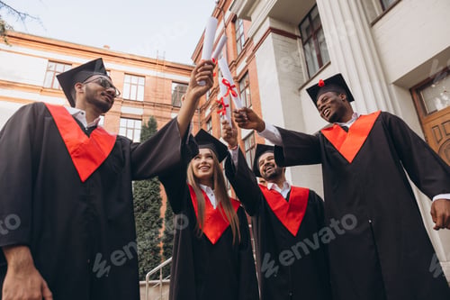 Preview: Group of Happy Graduates Celebrating Their Academic Achievement in Graduation Gowns and Caps Outdoor