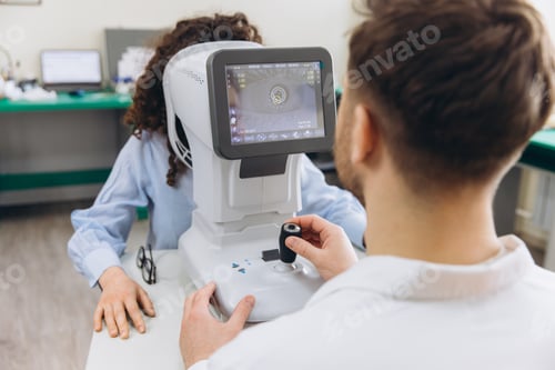 Preview: Optometrist conducting eye exam on a woman using an autorefractor, checking vision and eye health in