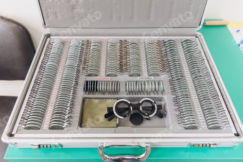 Preview: Trial lens set box open on green table, showing optical tools for vision diagnostic and eye examinat