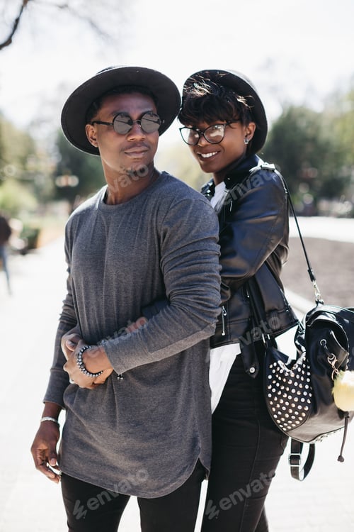 Preview: African American couple embracing on city street enjoying outdoor lifestyle and stylish urban fashio