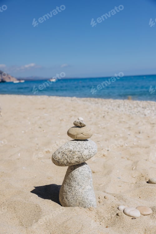 Preview: Zen balancing pebbles on a beach, representing harmony, mindfulness, and relaxation on Cala Luna, Sa