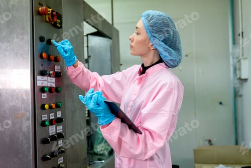 Preview: Caucasian factory worker hold tablet and control the machine by press the button and check