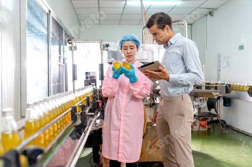 Preview: Asian factory worker hold yellow bottle and express also discuss with manager during work