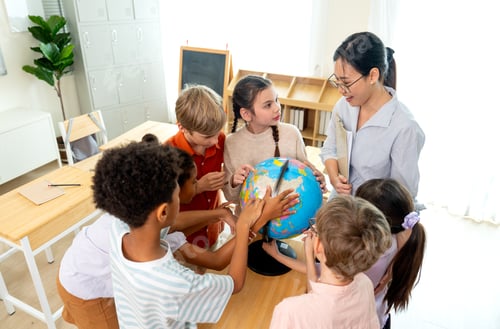 Preview: High view of teacher give the question about country on earth and tell the kids point on model globe