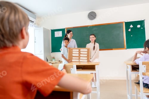 Preview: Back of the boy sit in the classroom and look to the front of class that boy and girl present