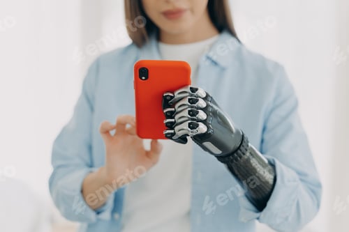 Preview: Focused Woman with Prosthetic Hand Using Smartphone in Close Up for Accessibility and Assistive Tech