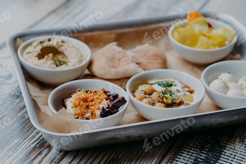 Preview: Food and nutrition concept. Traditional Israel dish for dinner. Tray of delicious hummus, beet with