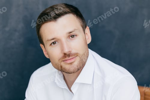 Preview: Isolated shot of handsome young male corporate worker dressed in elegant white shirt, poses against