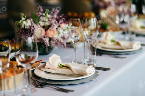 Preview: Table served for special occasion. Empty plate, glasses, forks, napkin and flowers on table covered