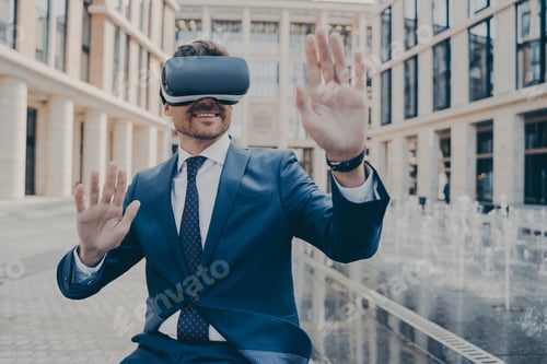 Preview: Excited office worker in formal suit checking information in virtual reality