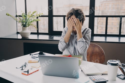 Preview: Curious woman office employee covering eyes with hands while getting x-mas present at work