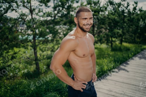 Preview: Athletic Man Standing Outdoors After Workout on Boardwalk in Green Park