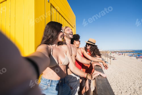 Preview: Diverse friends taking selfie smiling on summer beach