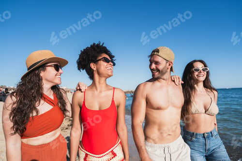 Preview: Friends enjoying summer vacation walking on sunny beach