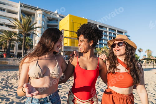 Preview: Diverse friends enjoying summer walk along beach