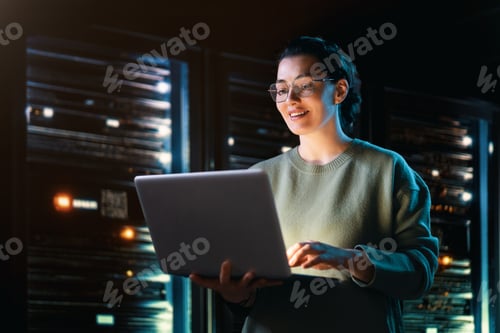 Preview: Confident Female IT Specialist Working Late in Server Room