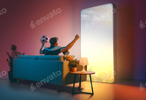 Preview: Man Watching Soccer on Giant Futuristic Screen at Home