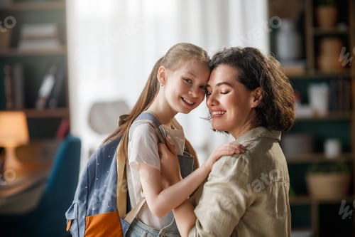 Preview: Happy Mother and Daughter Embracing Before School at Home