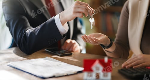 Preview: Real Estate Agent Handing Over House Keys to New Homeowner, Successful Property Purchase