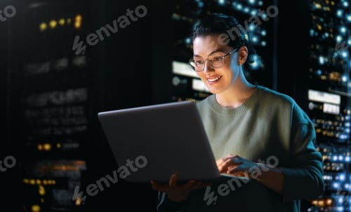 Preview: Confident Female IT Specialist Working Late in Server Room
