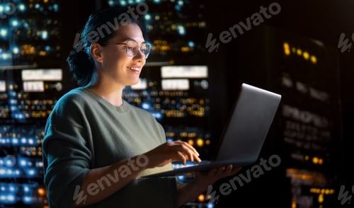 Preview: Confident IT Professional Working on Laptop in Modern Data Center