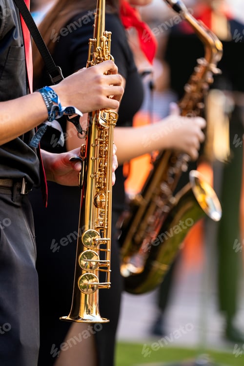 Preview: Young musician performing on a saxophone during a vibrant street concert in spain