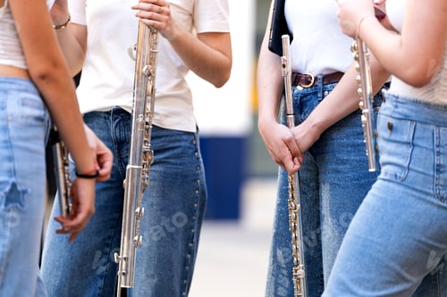 Preview: Young spanish musicians holding flutes, preparing for a street concert performance