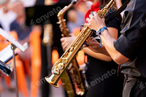 Preview: Young spanish musicians performing jazz music with saxophones during a street festival